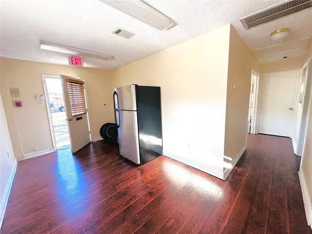 a very nice looking room with wooden floor and a window