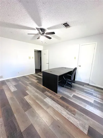 a room with furniture and a ceiling fan