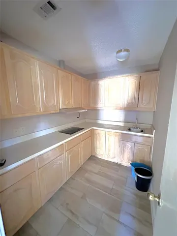 a kitchen with a sink cabinets and window