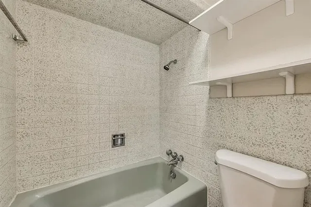 a bathroom with a toilet a sink and bathtub