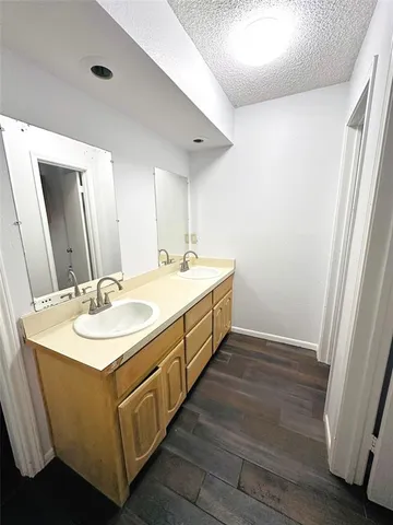 a spacious bathroom with a double vanity sink and a mirror