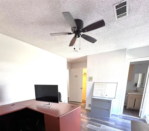 a living room with a flat screen tv and white walls