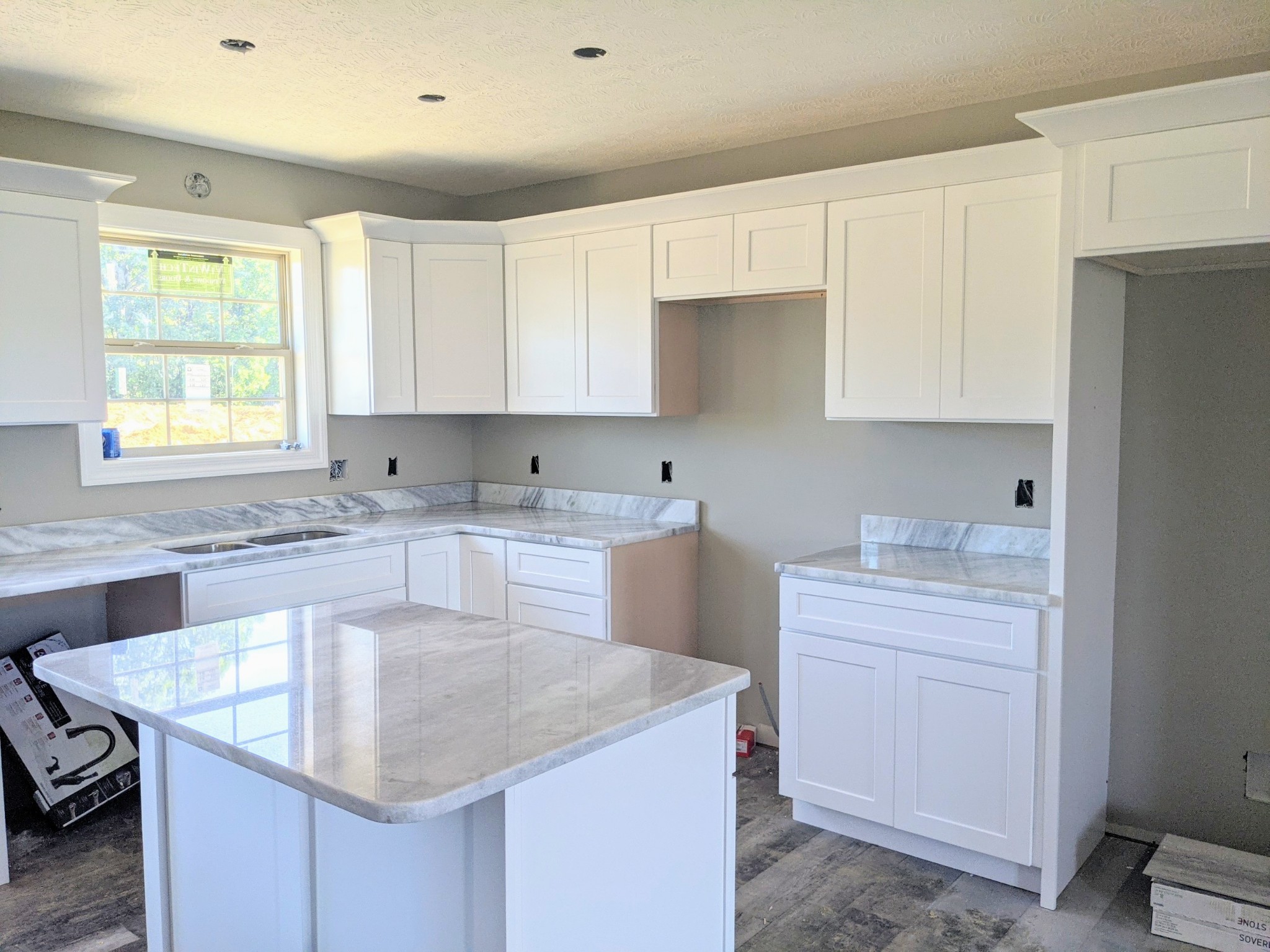278 Claypool Road Bethpage, TN 37022 - Photo 3 of 4 a kitchen with kitchen island granite countertop a sink a center island and cabinets