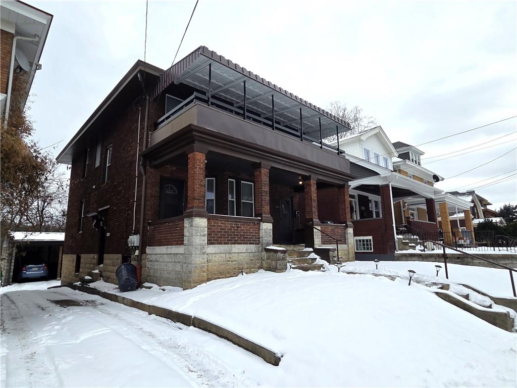 a view of a building with snow on the road