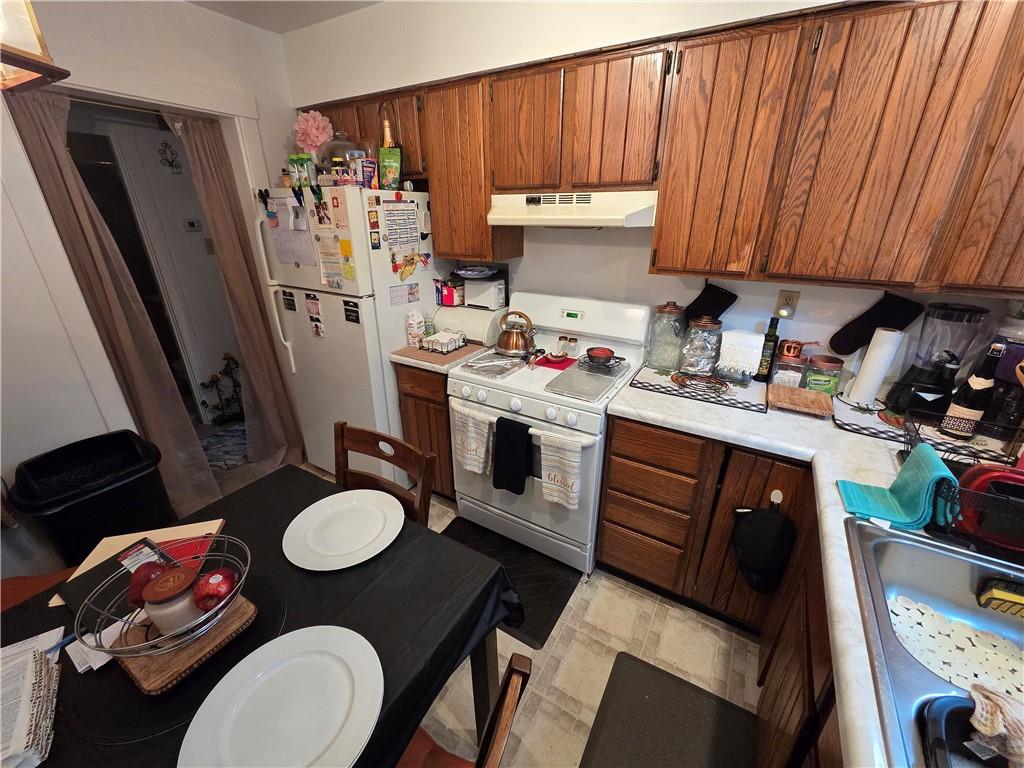 3520 Campus Street Pittsburgh, PA 15212 - Photo 17 of 26 a kitchen with a refrigerator a stove a sink dishwasher and wooden floor