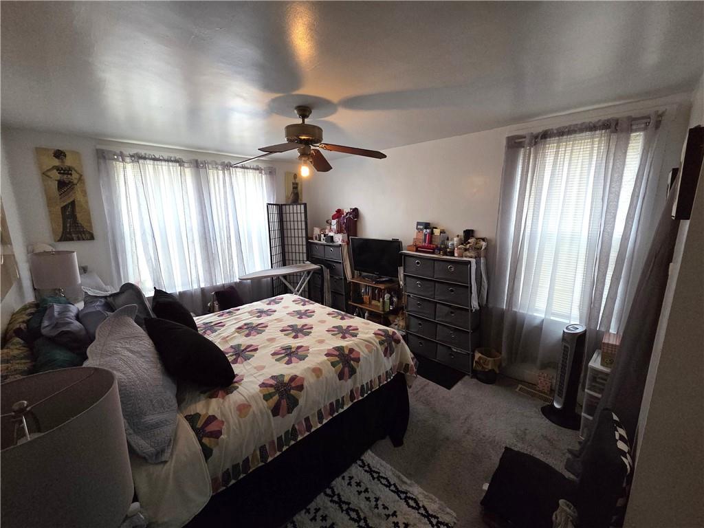 3520 Campus Street Pittsburgh, PA 15212 - Photo 22 of 26 a bedroom with a bed and a chandelier