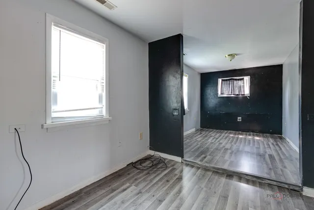 a view of hallway with wooden floor