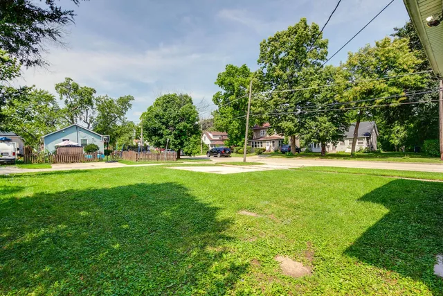 a house view with swimming pool in front of it