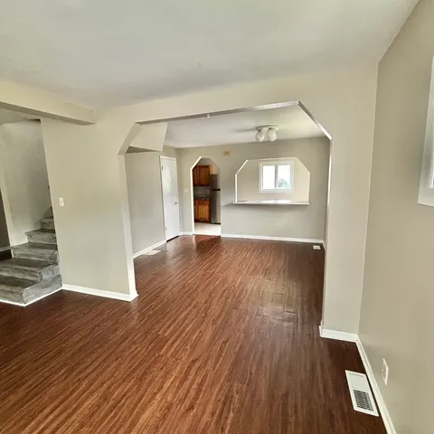 a view of a living room with wooden floor