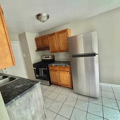 a kitchen with stainless steel appliances a refrigerator and a stove top oven