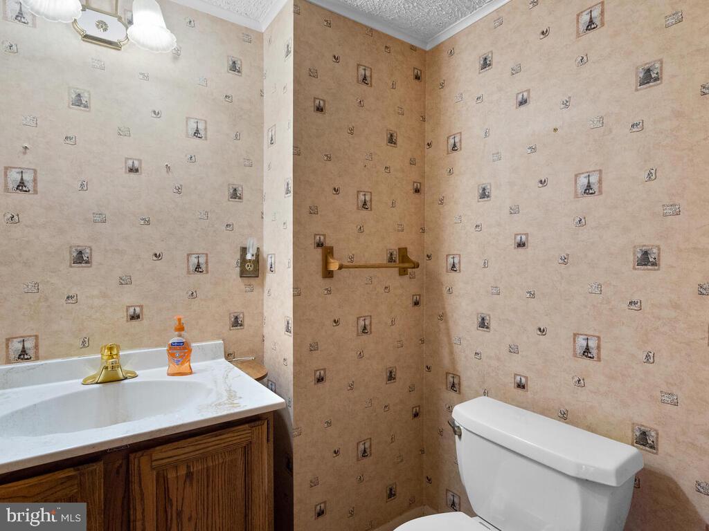 12714 Teaberry Road Silver Spring, MD 20906 - Photo 26 of 30 a bathroom with a sink toilet and a mirror