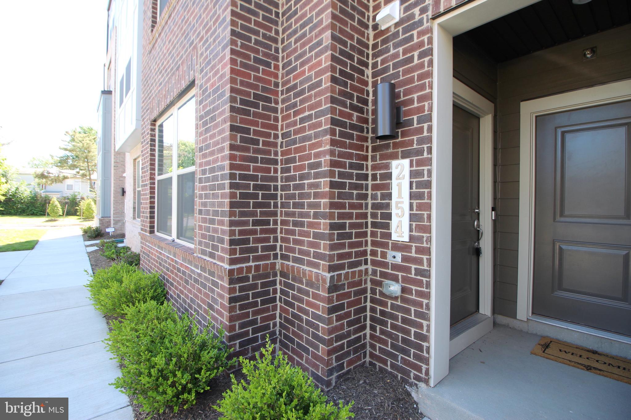 2154 Glacier Road, Unit 67 Herndon, VA 20170 - Photo 2 of 30 a view of a brick house with a yard