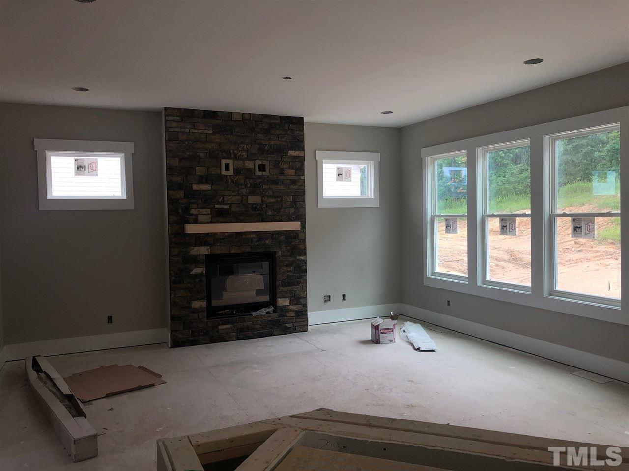 477 Adkins Ridge Road Rolesville, NC 27571 - Photo 6 of 30 Open Family room, stone fireplace with floating wood mantel