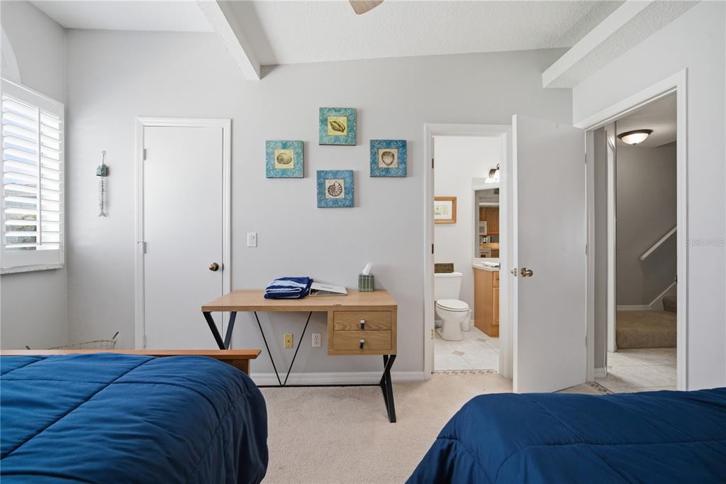 643 Garland Circle Indian Rocks Beach, FL 33785 - Photo 32 of 81 a bedroom with a bed and a chair in it