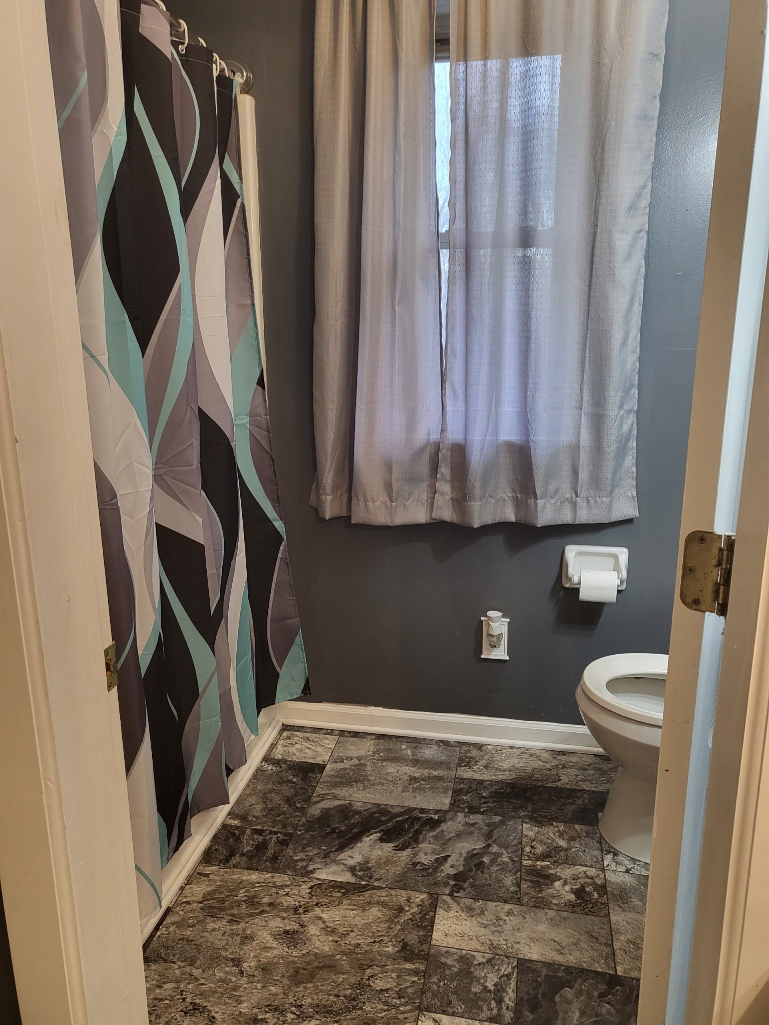 1393 Pomona Road Dickson, TN 37055 - Photo 29 of 32 a bathroom with a toilet and a shower curtain