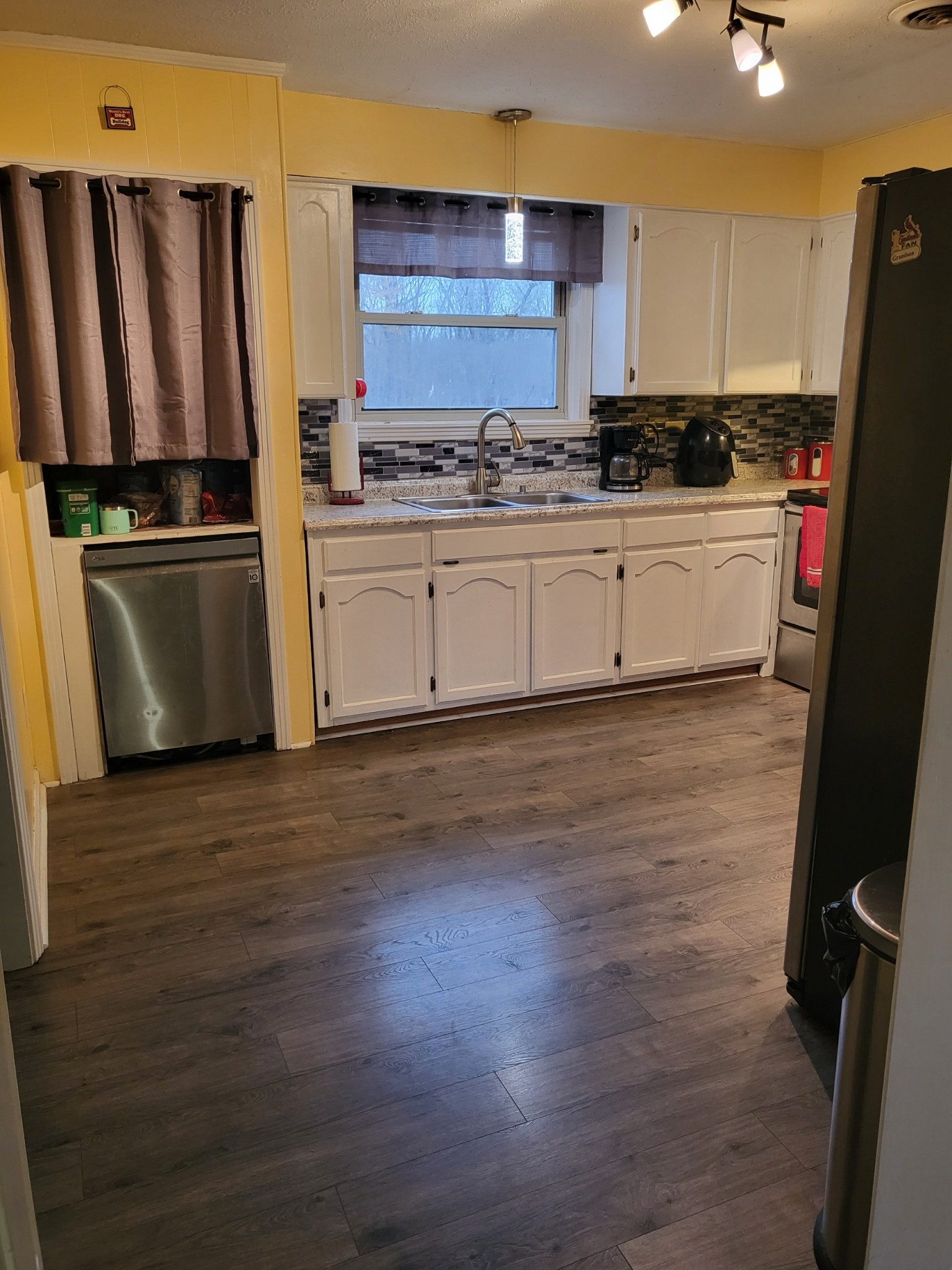1393 Pomona Road Dickson, TN 37055 - Photo 30 of 32 a kitchen with stainless steel appliances a refrigerator sink and wooden floor