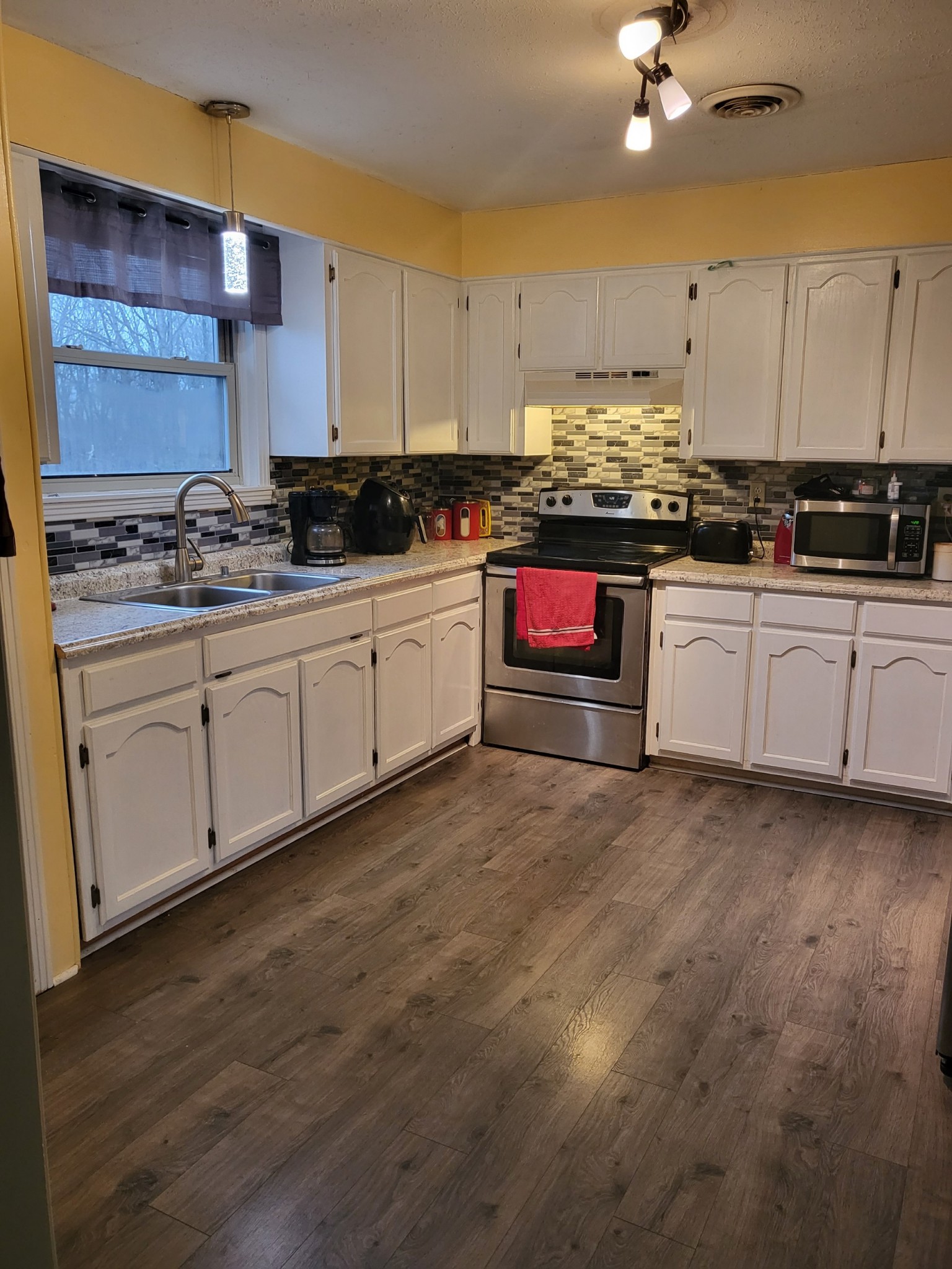 1393 Pomona Road Dickson, TN 37055 - Photo 32 of 32 a kitchen with stainless steel appliances granite countertop a stove and a sink