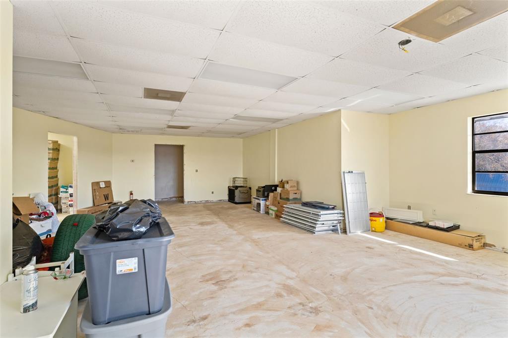 1108 Commercial Way Spring Hill, FL 34606 - Photo 14 of 17 a living room with furniture and a flat screen tv