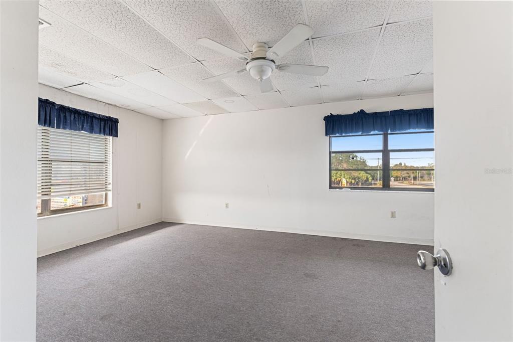 1108 Commercial Way Spring Hill, FL 34606 - Photo 3 of 17 an empty room with windows