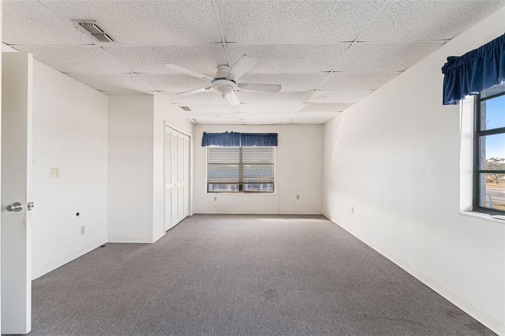 1108 Commercial Way Spring Hill, FL 34606 - Photo 4 of 17 a view of a livingroom with a window and a ceiling fan