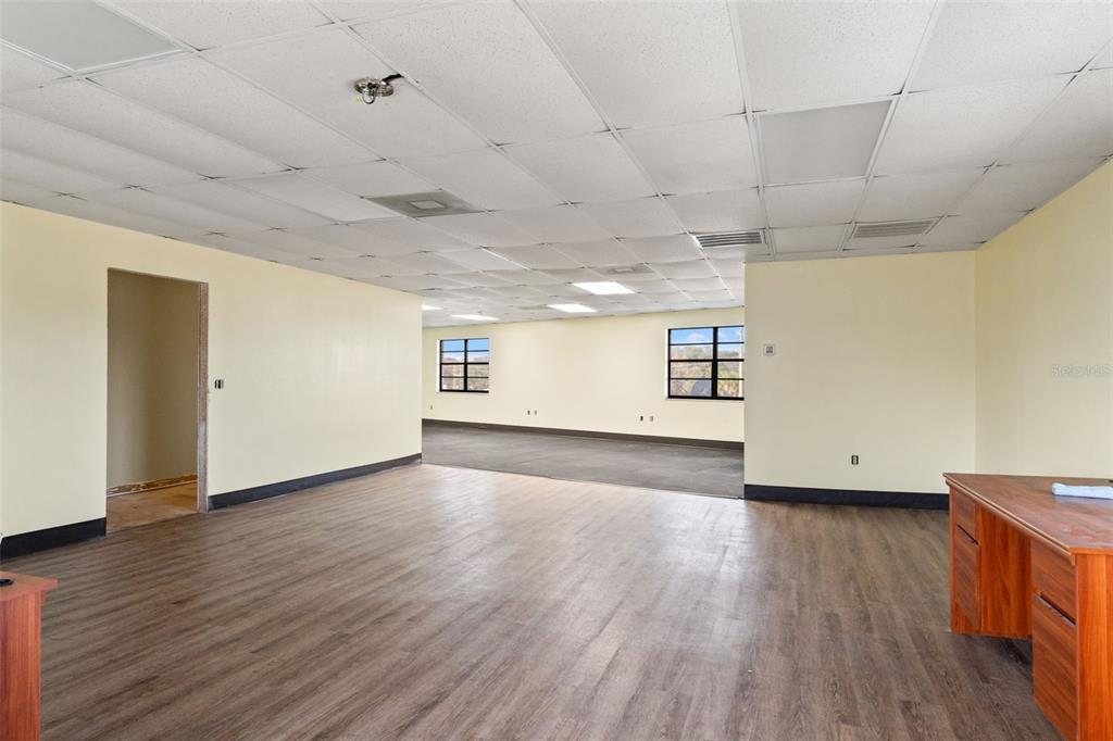 1108 Commercial Way Spring Hill, FL 34606 - Photo 5 of 17 a view of an empty room with wooden floor