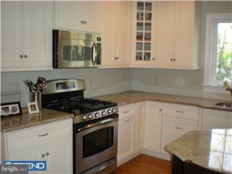 210 Middletown Road Media, PA 19063 - Photo 2 of 11 a kitchen with granite countertop white cabinets and a stove