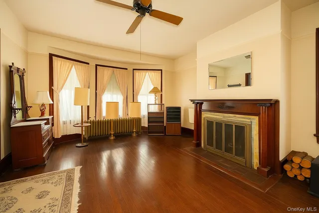 a view of a livingroom with furniture a fireplace and wooden floor