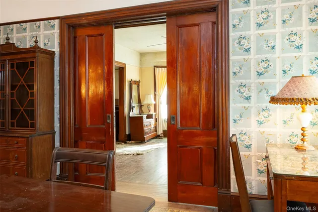 a kitchen with a table chairs refrigerator and cabinets