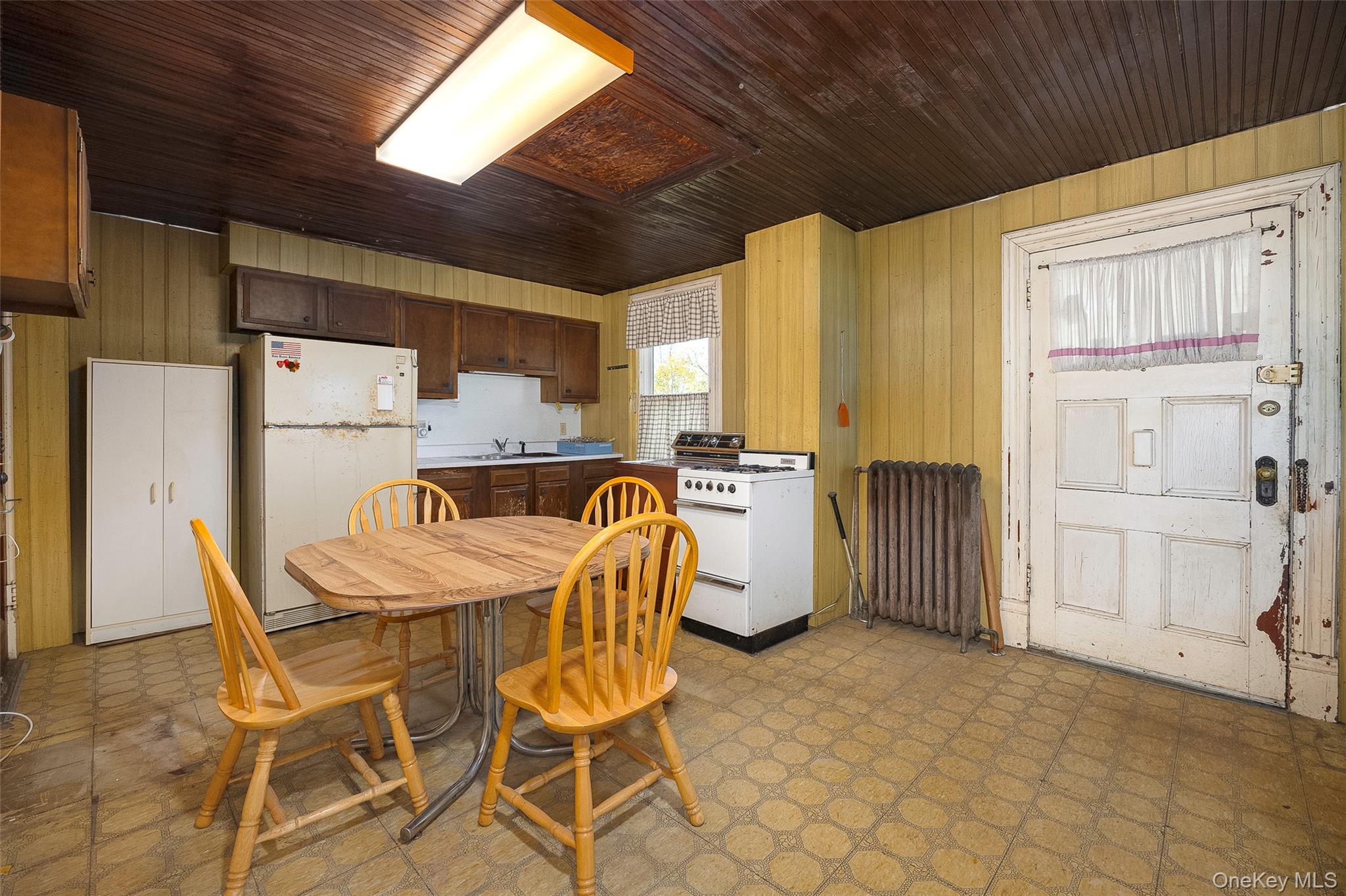 3 Spring Street Chelsea, NY 12590 - Photo 19 of 39 a kitchen with a table chairs refrigerator and cabinets