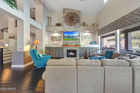 a kitchen with stainless steel appliances a dining table chairs and wooden floor