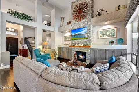 a kitchen with stainless steel appliances kitchen island granite countertop a dining table chairs and granite counter tops