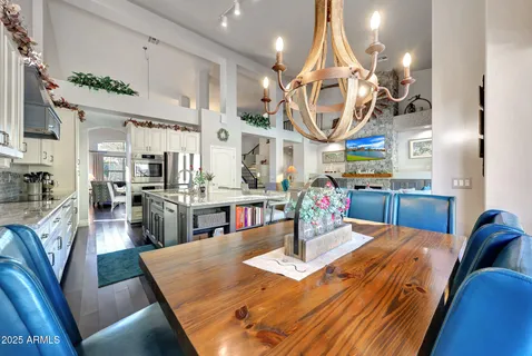 a bedroom with a large bed and a chandelier