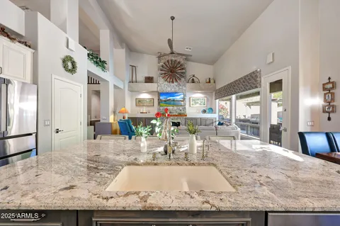 a bathroom with a granite countertop tub sink and mirror