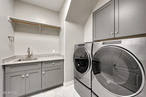 a bathroom with a granite countertop tub sink and mirror