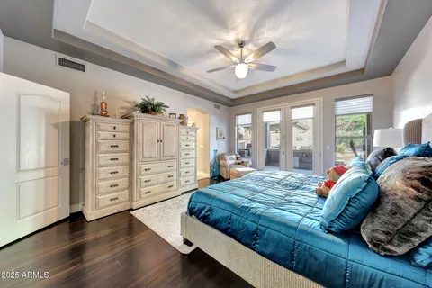 a bedroom with a bed and a chandelier