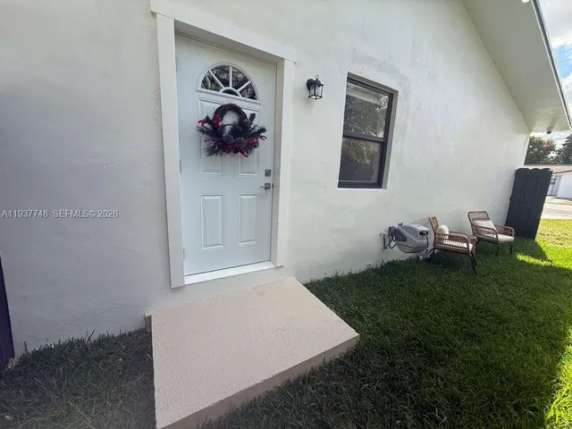 a backyard of a house with table and chairs