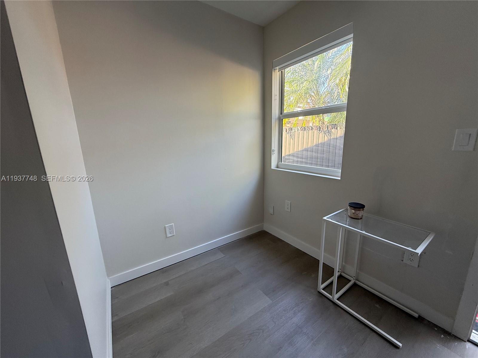 10785 Southwest 26th Street, Unit A Miami, FL 33175 - Photo 4 of 9 an empty room with a window