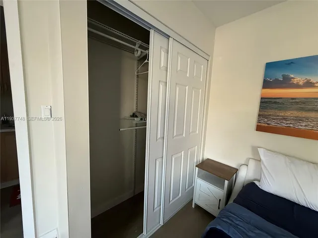 a white toilet sitting next to a sink