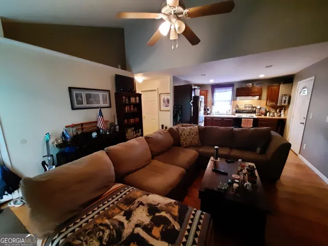 a bedroom with a bed window and a ceiling fan