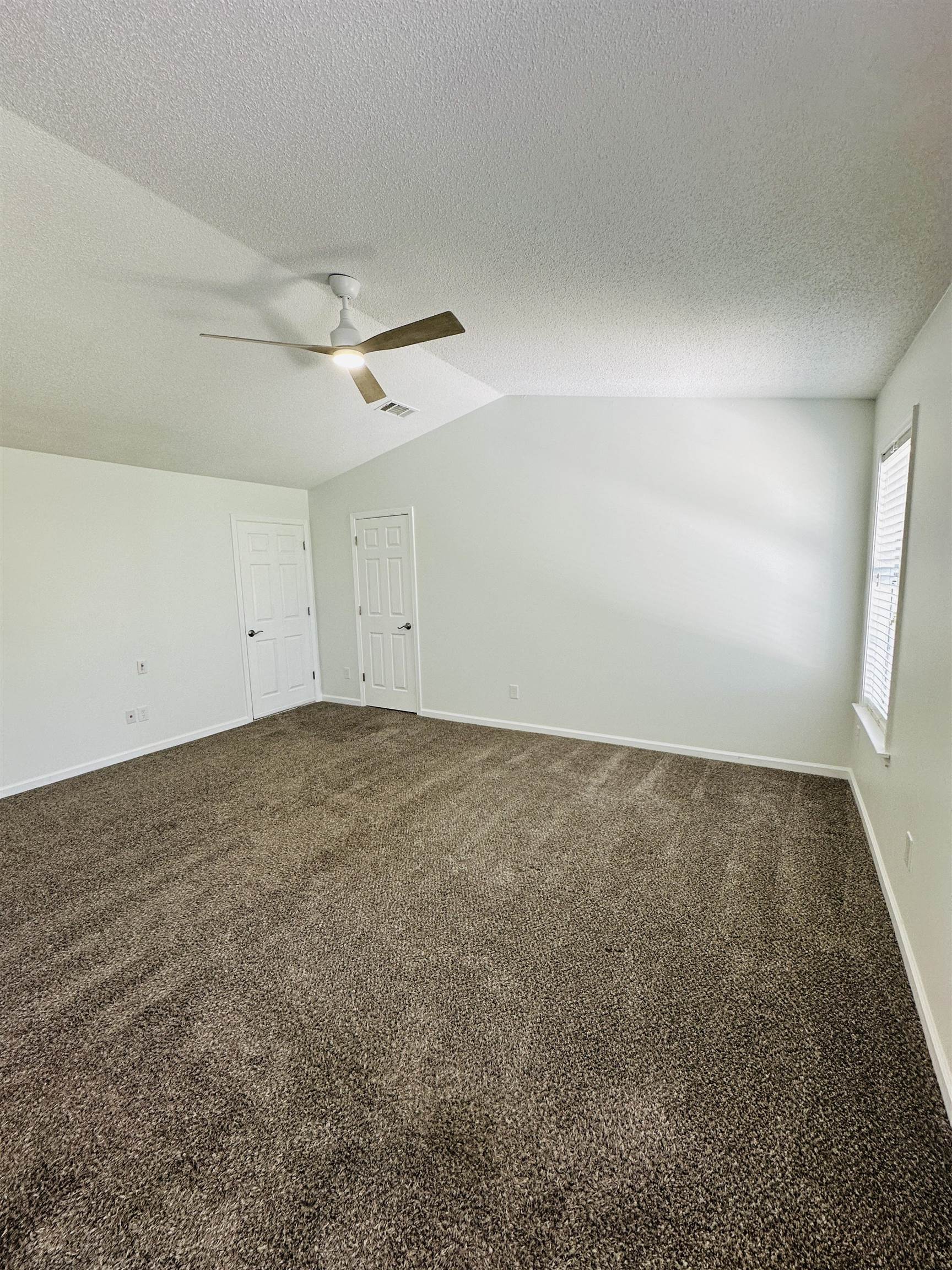 10006 Cameron Ridge Trail Memphis, TN 38016 - Photo 14 of 29 an empty room with a ceiling fan and window
