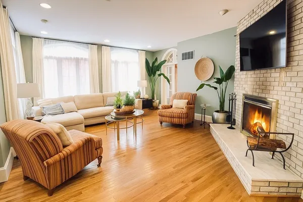a living room with furniture fireplace and flat screen tv