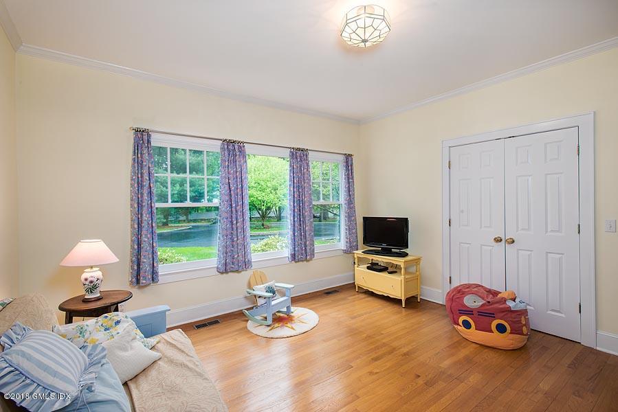 596 Riversville Road Greenwich, CT 06831 - Photo 18 of 24 a bedroom with furniture and a window