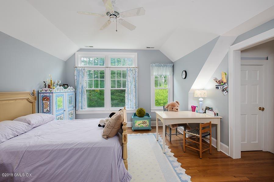596 Riversville Road Greenwich, CT 06831 - Photo 23 of 24 a bed room with a bed and a table