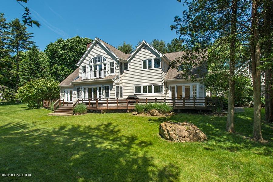 596 Riversville Road Greenwich, CT 06831 - Photo 4 of 24 a view of a house with a yard table and chairs