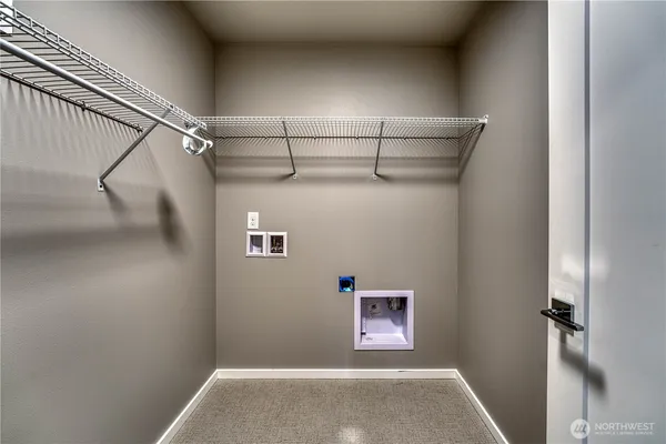 a view of storage and utility room with racks on the wall