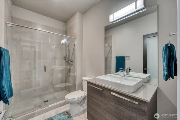 a bathroom with a sink a toilet and shower