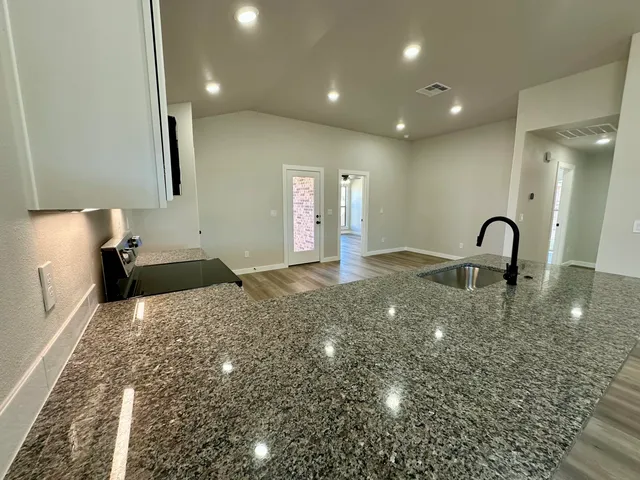 a kitchen with a sink and a stove top oven