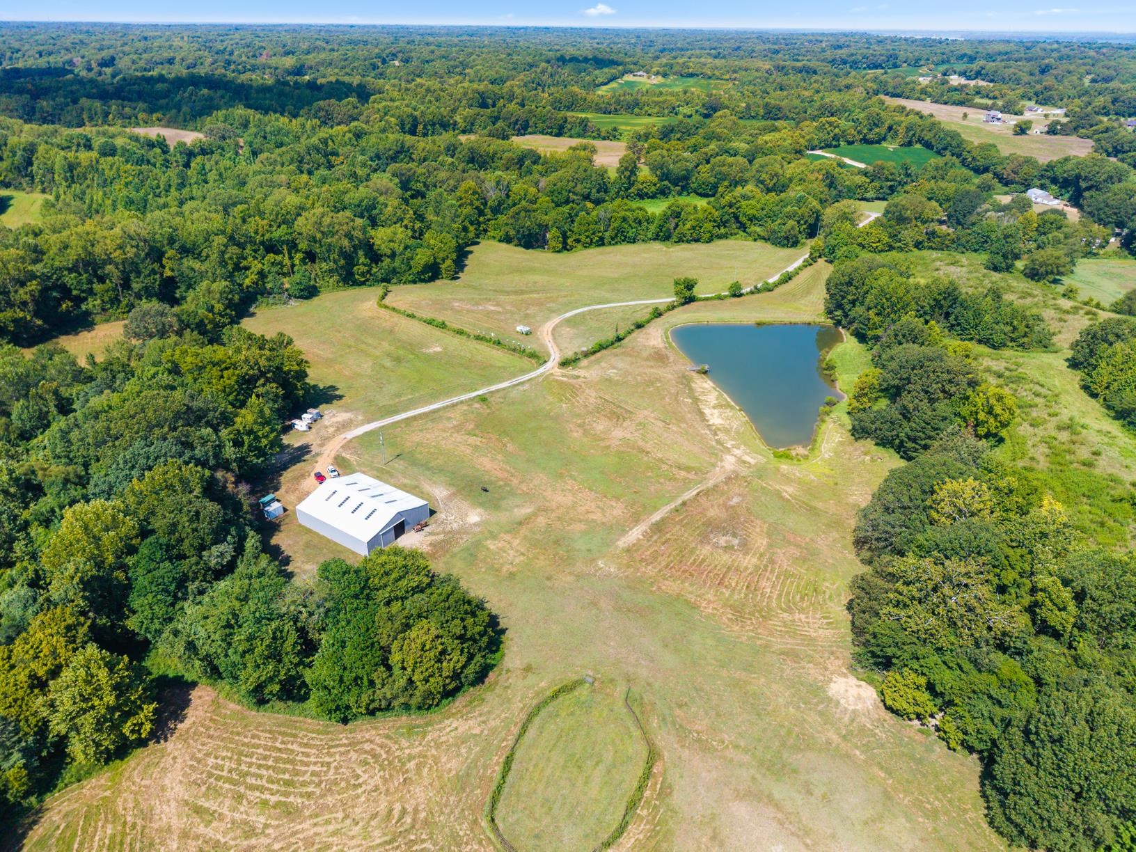 an aerial view of a house with a yard and lake view