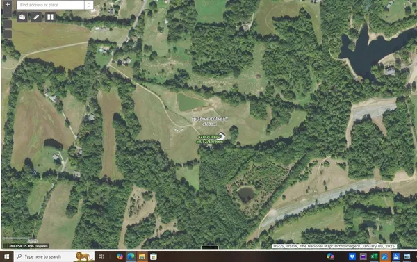 an aerial view of a residential houses with outdoor space