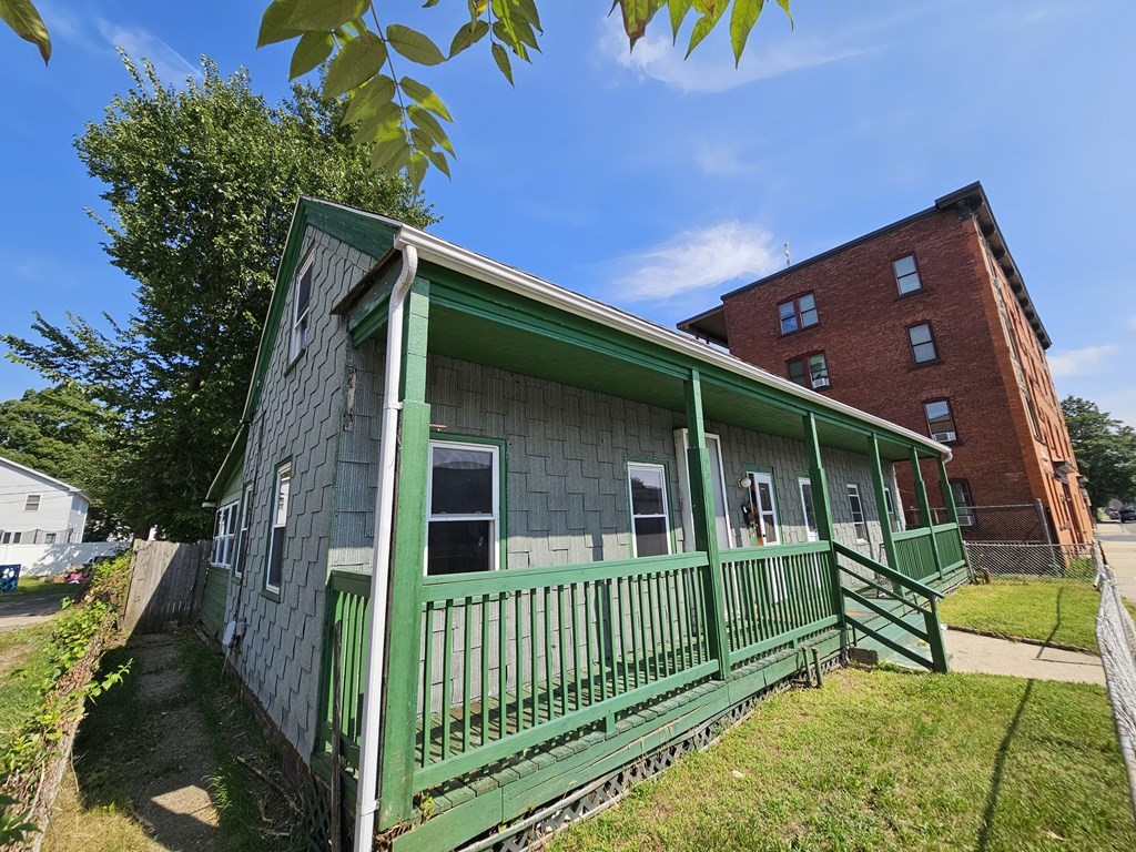 118 Tyler Street Springfield, MA 01109 - Photo 3 of 15 a view of a house with a yard and deck